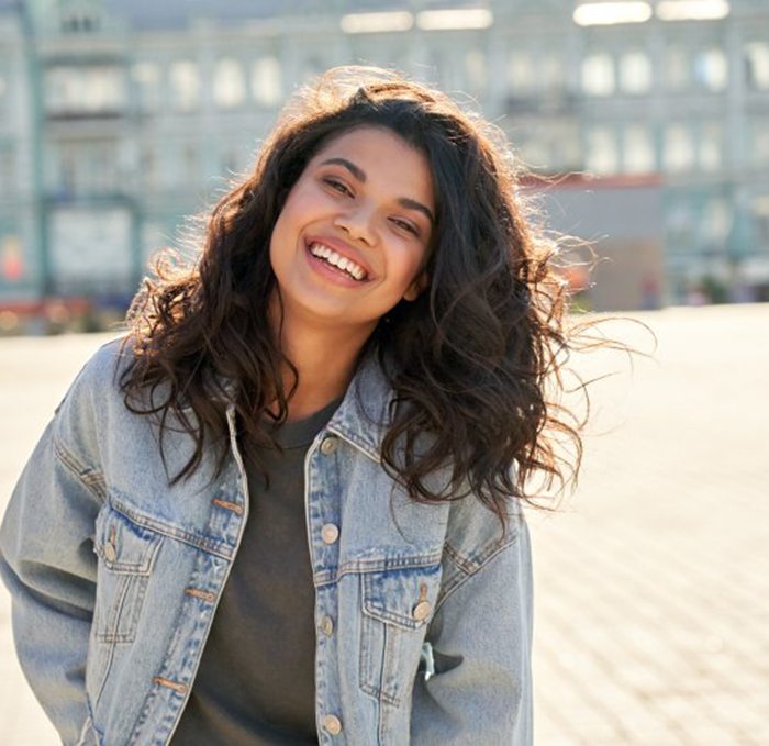 Lady smiles while talking on phone
