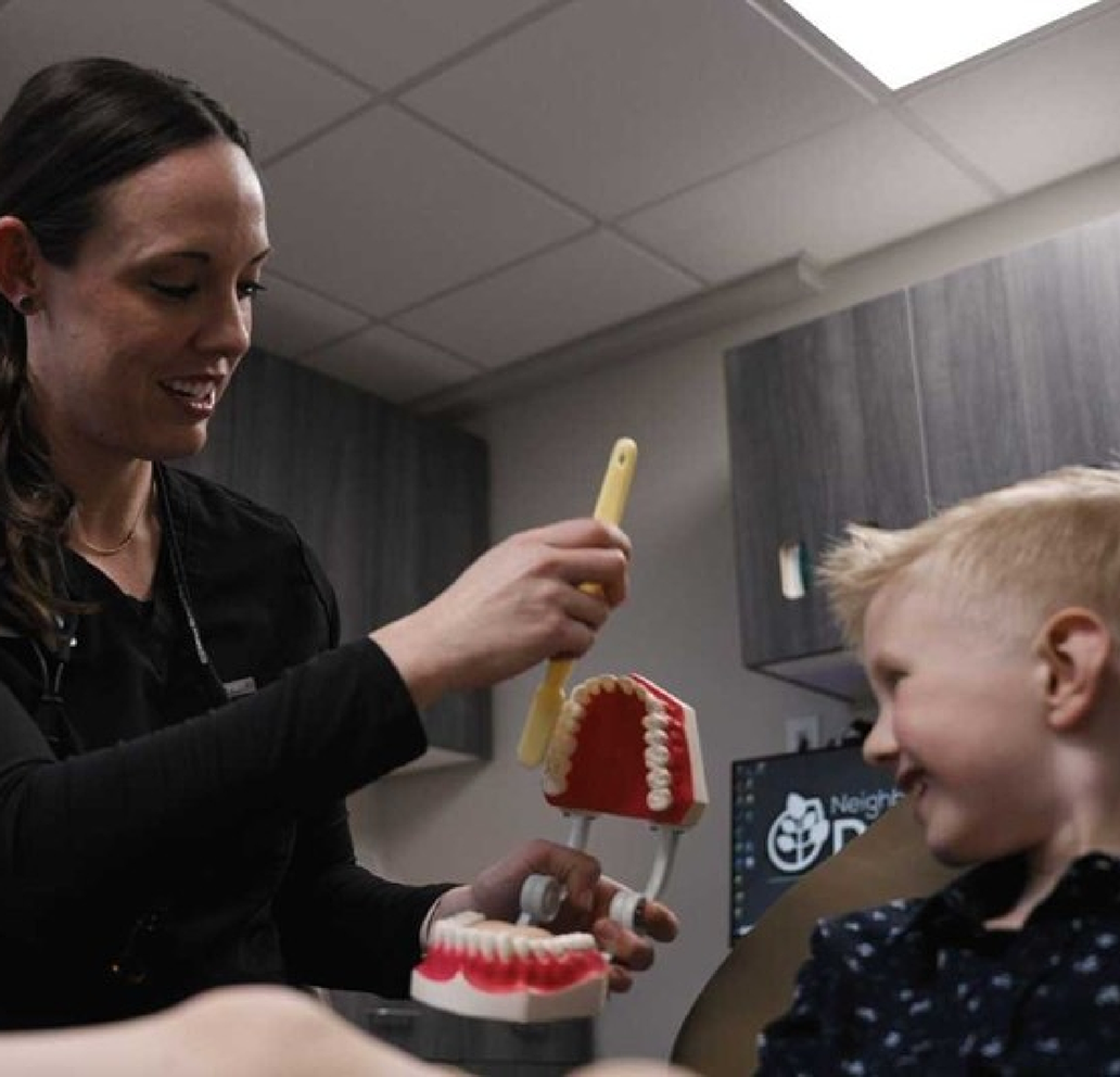 Pediatric dentist in Brandon examining young patient