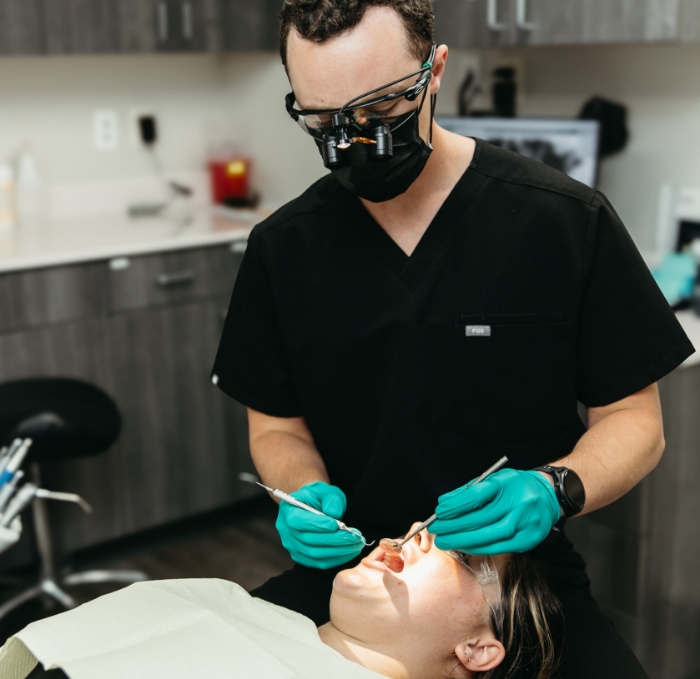 Dentist and team member giving a patient a dental exam