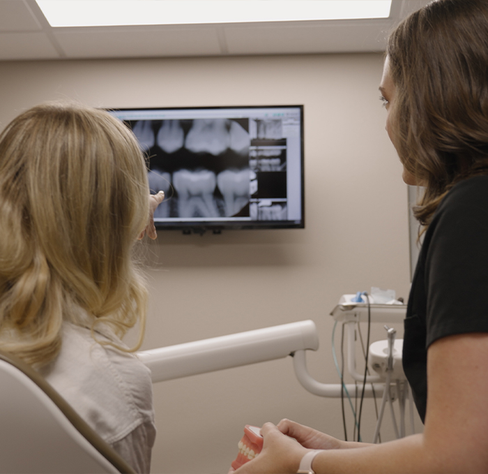 Dentist showing a patient X rays of their teeth