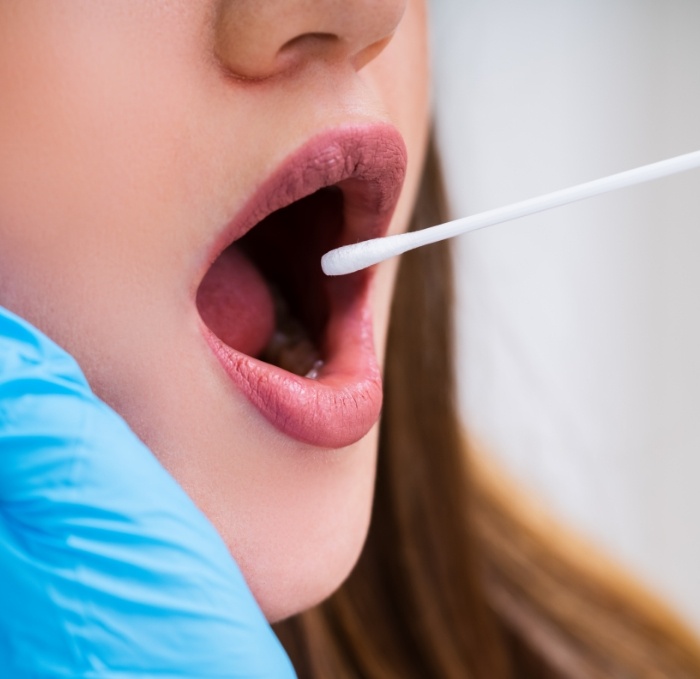 Woman receiving saliva swab