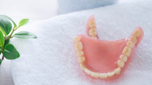 a pair of dentures sitting atop a towel