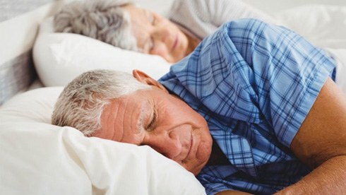 a mature couple sleeping without their dentures on