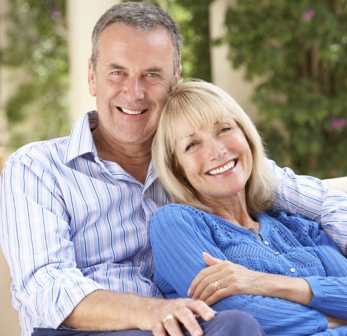 Senior man and woman smiling with dentures in Brandon