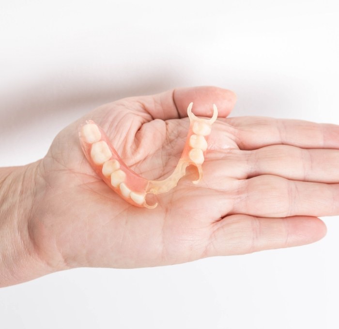 Hand holding a partial denture