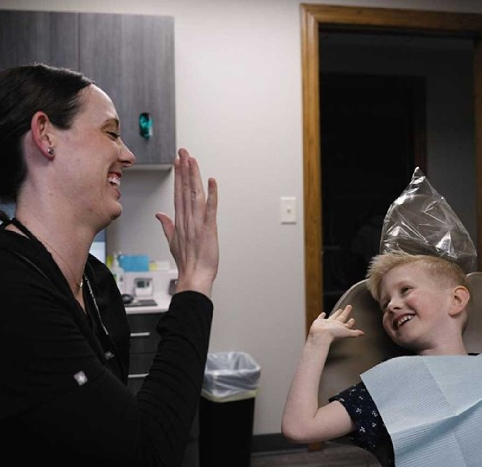 a dentist and their team smling