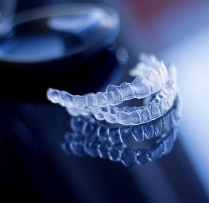 Two Invisalign aligners resting on table