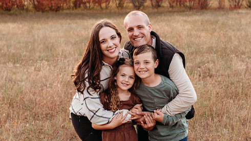 Doctor Heesch with her husband and two children outdoors