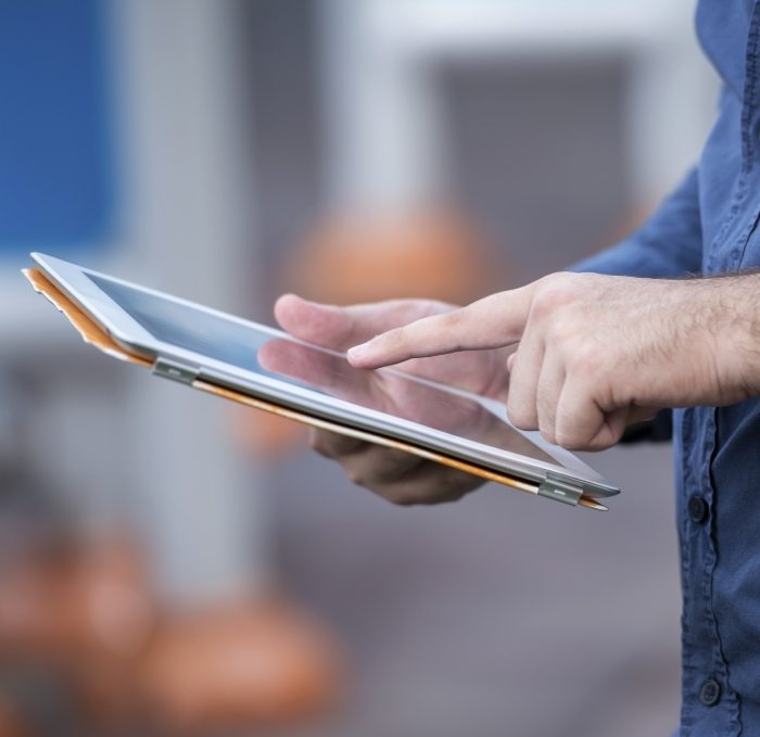 Person typing on tablet