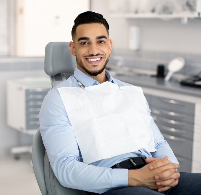 Smiling man sitting in dental chair