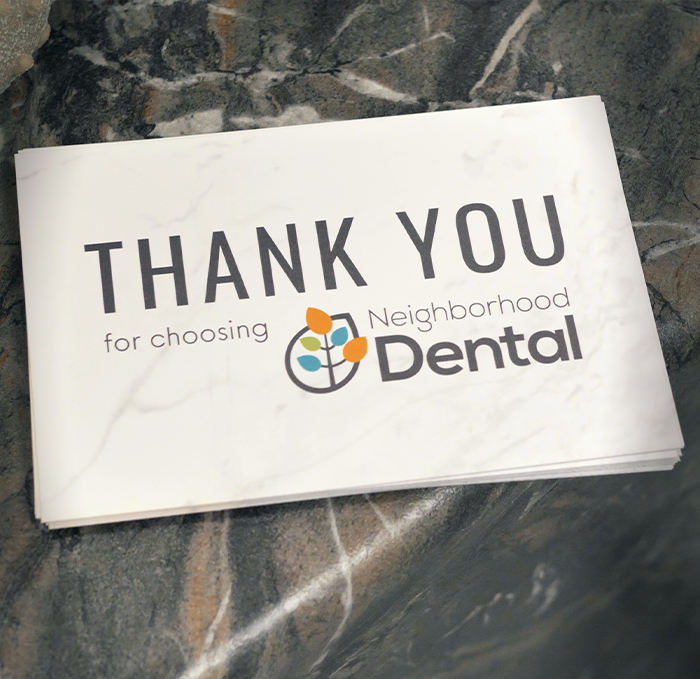 Stack of cards reading thank you for choosing Neighborhood Dental