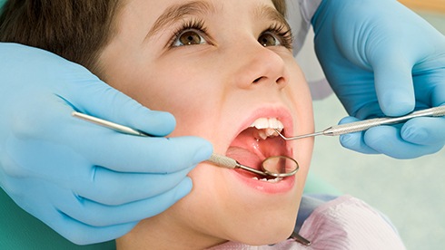 a child smiling during a dental visit  