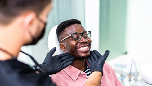 Patient smiling in dental chair after sedation