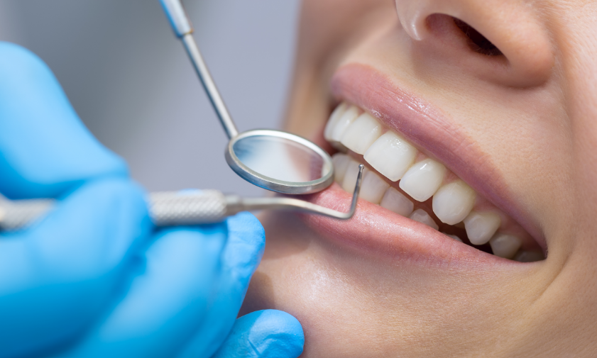 Close up of a smiling patient getting a dental cleaning